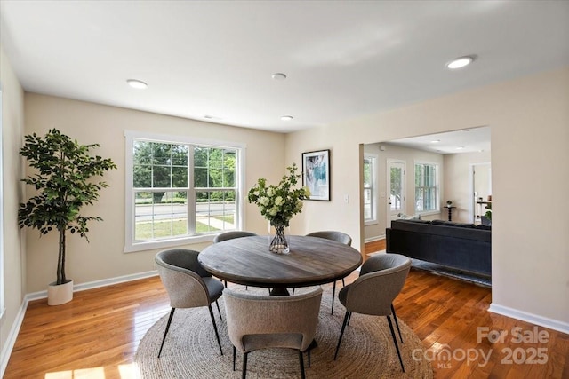 dining room featuring baseboards, recessed lighting, and wood finished floors