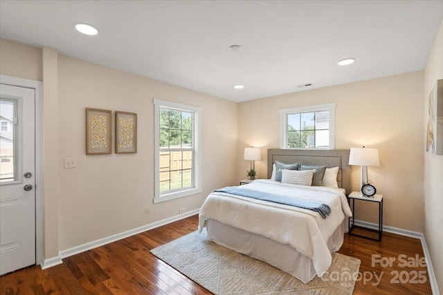 bedroom featuring baseboards and dark wood finished floors