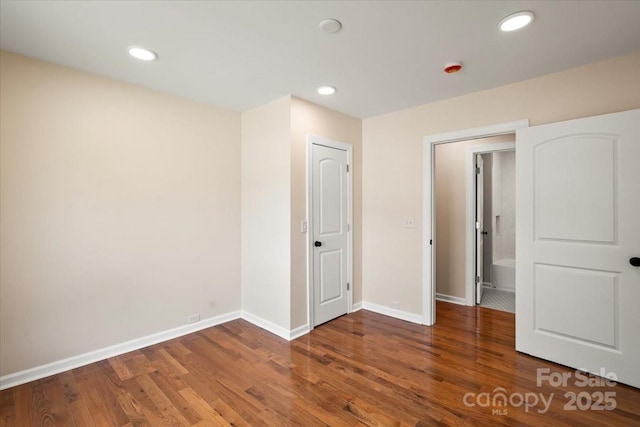 unfurnished bedroom with baseboards, recessed lighting, and wood finished floors