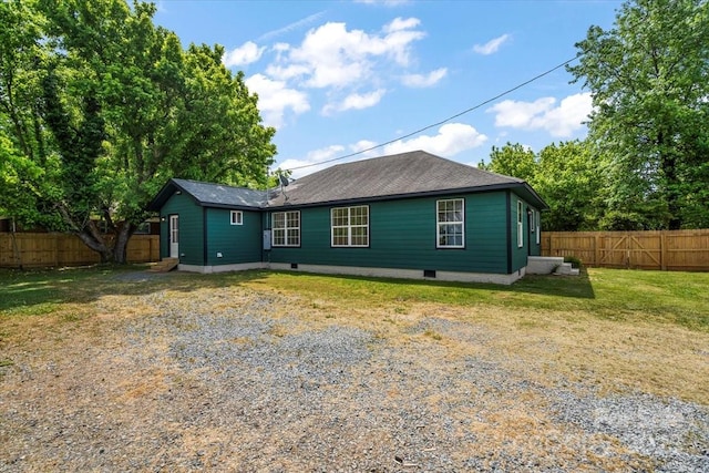 rear view of property with a lawn, a fenced backyard, and crawl space