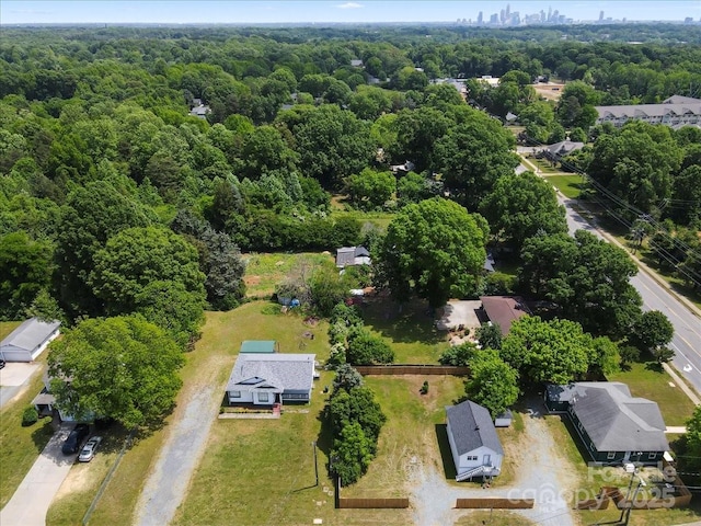 birds eye view of property with a wooded view