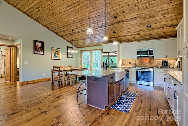 202 Wild Pear Ln Unit 3 & 7A, Franklin, NC 28734 - kitchen with appliances with stainless steel finishes, a sink, wood ceiling, white cabinetry, and decorative backsplash
