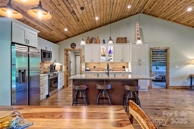 202 Wild Pear Ln Unit 3 & 7A, Franklin, NC 28734 - kitchen with appliances with stainless steel finishes, light wood finished floors, a sink, lofted ceiling, and white cabinets