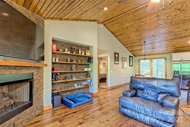 202 Wild Pear Ln Unit 3 & 7A, Franklin, NC 28734 - living room featuring wooden ceiling, light wood-style floors, vaulted ceiling, a stone fireplace, and a ceiling fan