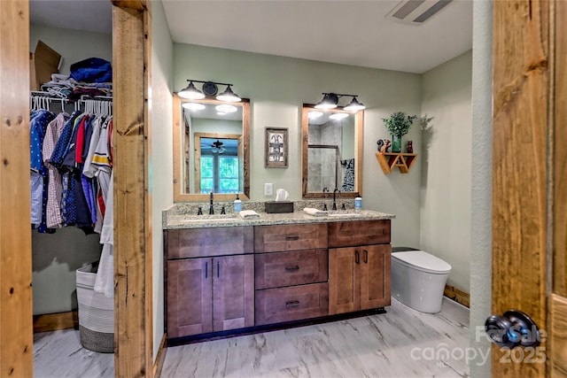 202 Wild Pear Ln Unit 3 & 7A, Franklin, NC 28734 - full bathroom featuring a shower stall, toilet, a walk in closet, a ceiling fan, and double vanity