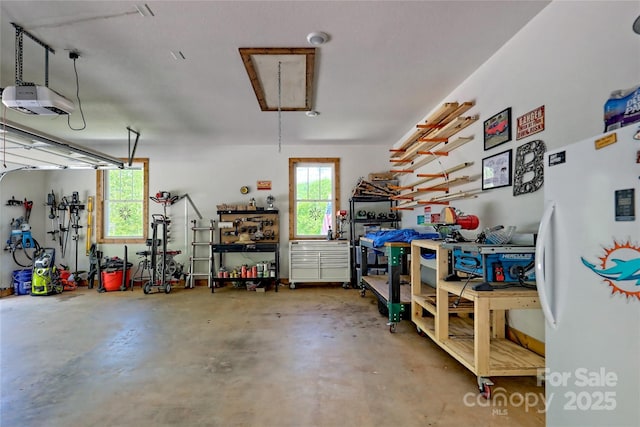 202 Wild Pear Ln Unit 3 & 7A, Franklin, NC 28734 - garage with a garage door opener, freestanding refrigerator, and a workshop area