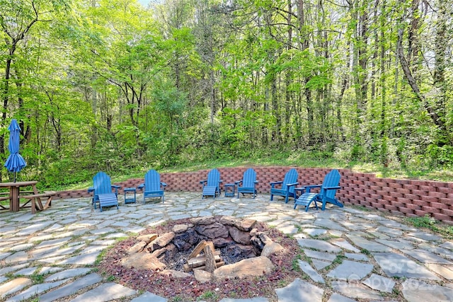 202 Wild Pear Ln Unit 3 & 7A, Franklin, NC 28734 - view of patio featuring a fire pit and a wooded view