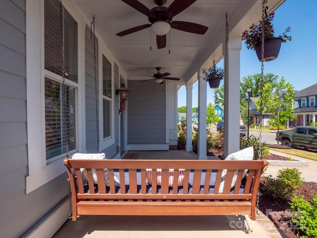 view of patio with a ceiling fan, a baseboard radiator, and a porch