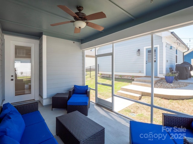 sunroom / solarium with a ceiling fan and outdoor lounge area