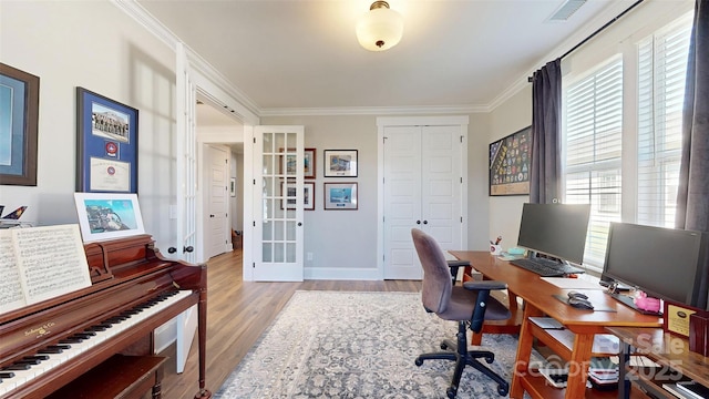 home office featuring crown molding, visible vents, wood finished floors, baseboards, and french doors