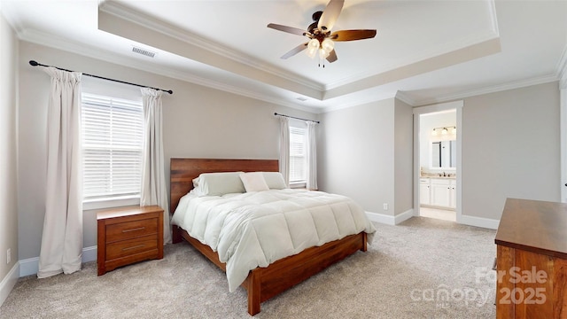 bedroom with visible vents, a raised ceiling, crown molding, and light carpet