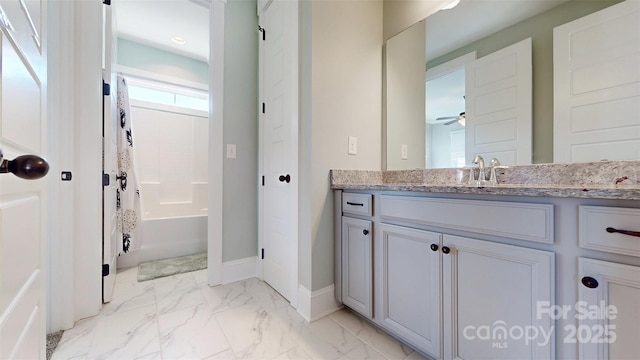 full bathroom with vanity, baseboards, shower / tub combo with curtain, and marble finish floor