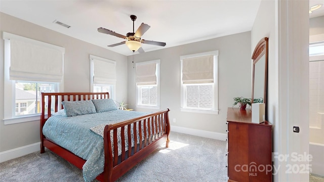 carpeted bedroom featuring baseboards, a ceiling fan, and visible vents