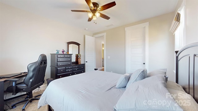 bedroom with light colored carpet, ceiling fan, and visible vents