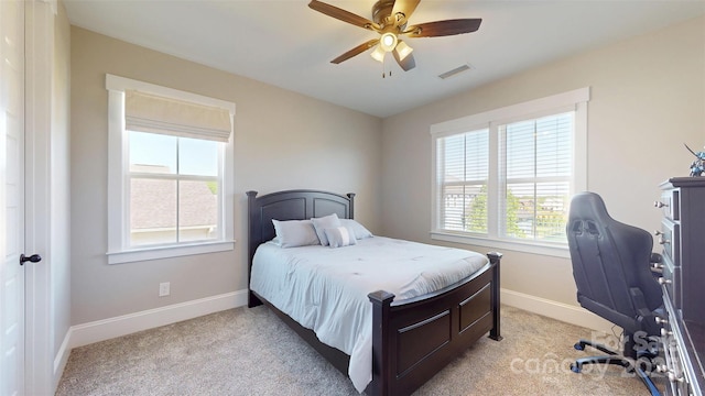 bedroom with baseboards, multiple windows, light carpet, and visible vents