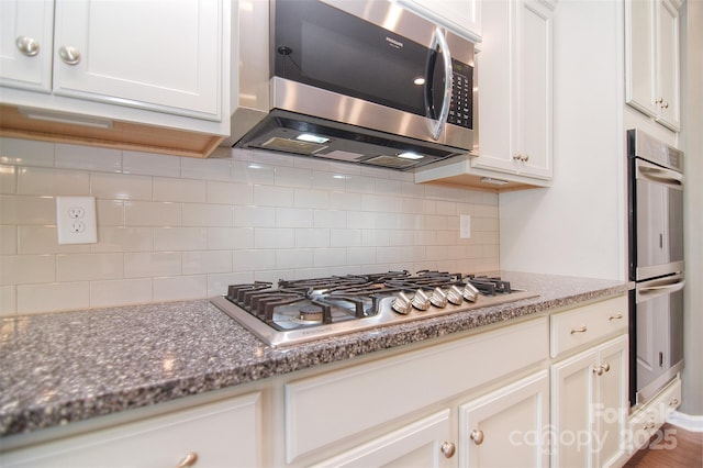 3073 Oliver Stanley Trl, Lancaster, SC 29720 - kitchen with white cabinets, appliances with stainless steel finishes, and tasteful backsplash