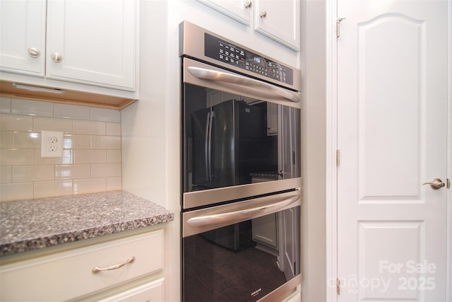 3073 Oliver Stanley Trl, Lancaster, SC 29720 - kitchen with light stone counters, stainless steel double oven, decorative backsplash, and white cabinets