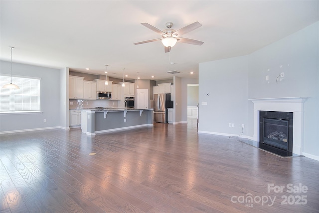 3073 Oliver Stanley Trl, Lancaster, SC 29720 - unfurnished living room featuring a ceiling fan, visible vents, baseboards, recessed lighting, and dark wood-type flooring