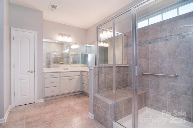3073 Oliver Stanley Trl, Lancaster, SC 29720 - bathroom with vanity, visible vents, tile patterned floors, a shower stall, and baseboards