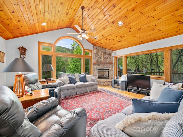 living room featuring wood finished floors, a fireplace, ceiling fan, high vaulted ceiling, and wood ceiling