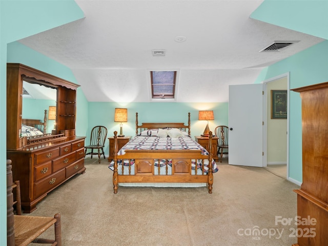 bedroom with visible vents, baseboards, and light carpet