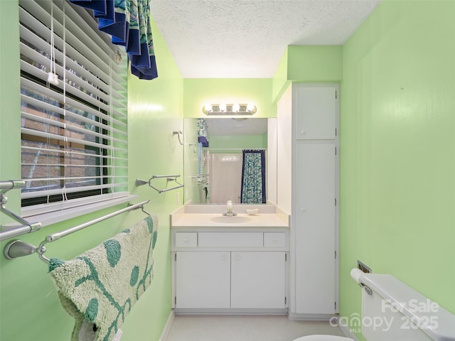 full bathroom featuring vanity, a textured ceiling, toilet, and a shower with curtain
