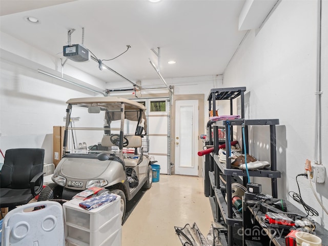garage featuring a garage door opener and recessed lighting