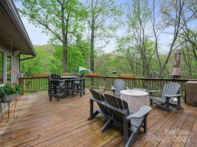 wooden terrace featuring outdoor dining space