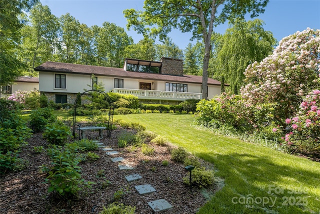 69 Forest Rd, Asheville, NC 28803 - rear view of house featuring stucco siding, stone siding, and a lawn