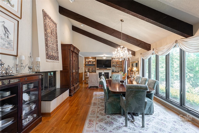 69 Forest Rd, Asheville, NC 28803 - dining room featuring beamed ceiling, a chandelier, light wood finished floors, high vaulted ceiling, and a textured ceiling
