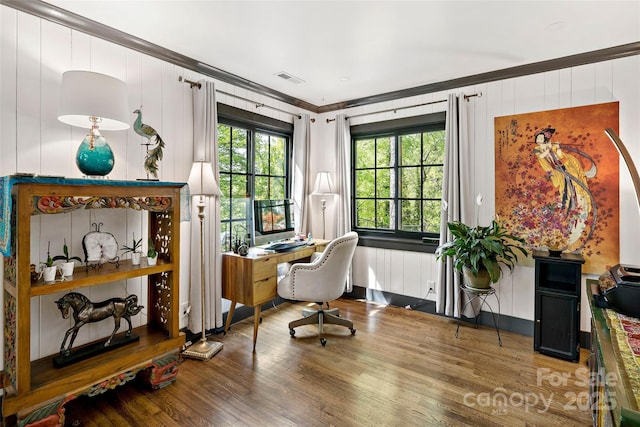 office space featuring visible vents, ornamental molding, and wood finished floors