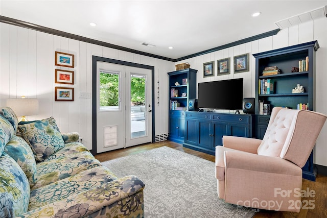 living room featuring visible vents, ornamental molding, wood finished floors, and recessed lighting