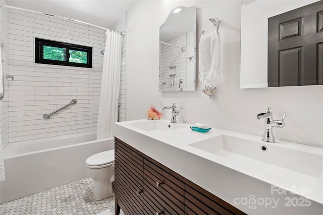 bathroom featuring double vanity, a sink, shower / tub combo with curtain, and toilet