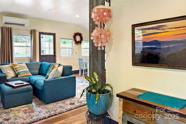 living area with a wall mounted AC, recessed lighting, wood finished floors, and lofted ceiling