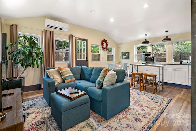 living area featuring recessed lighting, vaulted ceiling, dark wood-style floors, and a wall mounted air conditioner