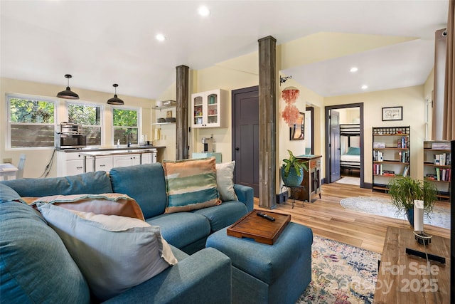 living area with vaulted ceiling, recessed lighting, and light wood-style flooring