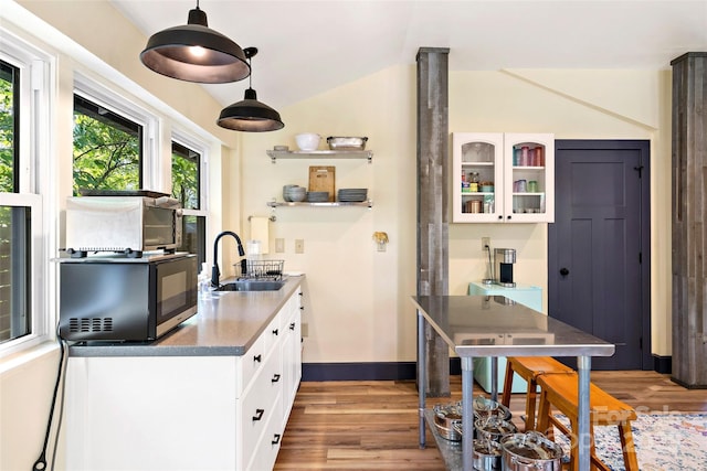 kitchen featuring light wood-style floors, a sink, open shelves, and white cabinets