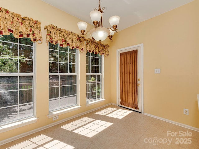 2825 Redfield Dr, Charlotte, NC 28270 - unfurnished dining area with a chandelier, baseboards, and tile patterned flooring