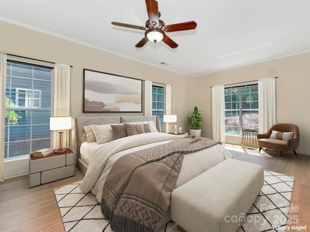 2825 Redfield Dr, Charlotte, NC 28270 - bedroom with light wood finished floors, multiple windows, crown molding, ceiling fan, and baseboards