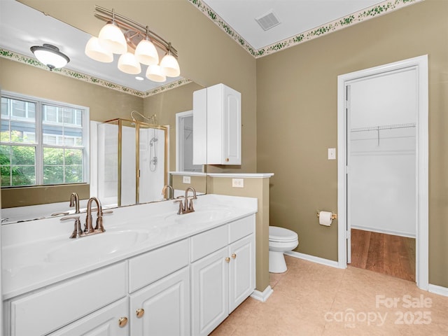 2825 Redfield Dr, Charlotte, NC 28270 - bathroom with a shower stall, toilet, double vanity, a walk in closet, and tile patterned floors