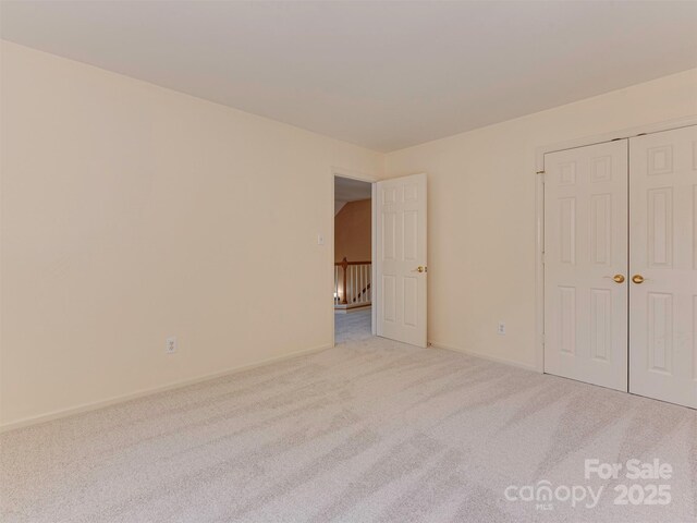 2825 Redfield Dr, Charlotte, NC 28270 - unfurnished bedroom featuring carpet flooring, a closet, and baseboards