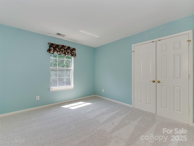 2825 Redfield Dr, Charlotte, NC 28270 - unfurnished bedroom with carpet, baseboards, and a closet