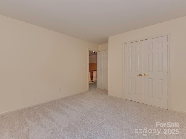2825 Redfield Dr, Charlotte, NC 28270 - unfurnished bedroom featuring carpet floors, a closet, and baseboards