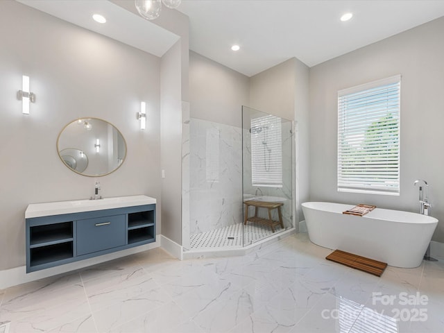 4315 Hartis Grove Church Rd, Indian Trail, NC 28079 - bathroom featuring marble finish floors, a marble finish shower, a freestanding tub, vanity, and recessed lighting