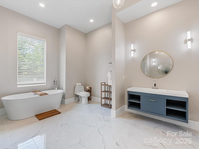 4315 Hartis Grove Church Rd, Indian Trail, NC 28079 - bathroom featuring a freestanding tub, vanity, marble finish flooring, and recessed lighting