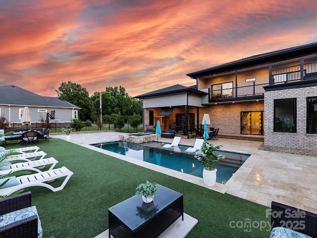 4315 Hartis Grove Church Rd, Indian Trail, NC 28079 - pool at dusk featuring an outdoor hangout area, a patio area, and a pool with connected hot tub