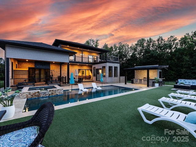 4315 Hartis Grove Church Rd, Indian Trail, NC 28079 - back of property at dusk featuring a patio, a yard, a balcony, and brick siding