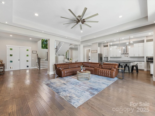 4315 Hartis Grove Church Rd, Indian Trail, NC 28079 - living room featuring recessed lighting, stairway, a ceiling fan, light wood-style flooring, and a tray ceiling