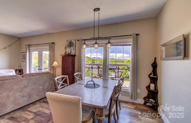 dining space with french doors and wood finished floors