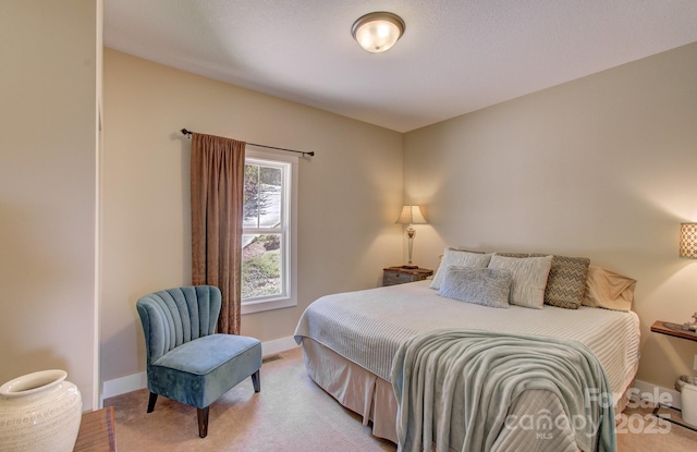 bedroom featuring baseboards and light colored carpet